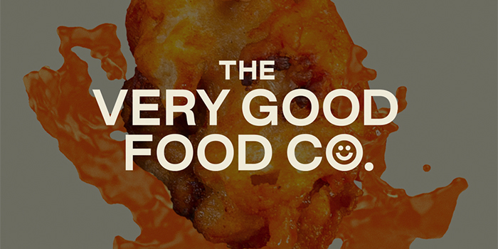The Very Good Food Company logo with a sauce covered chicken nugget in background
