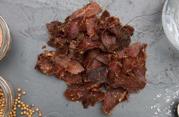 Biltong is made by marinating beef in spices and vinegar before air-drying it